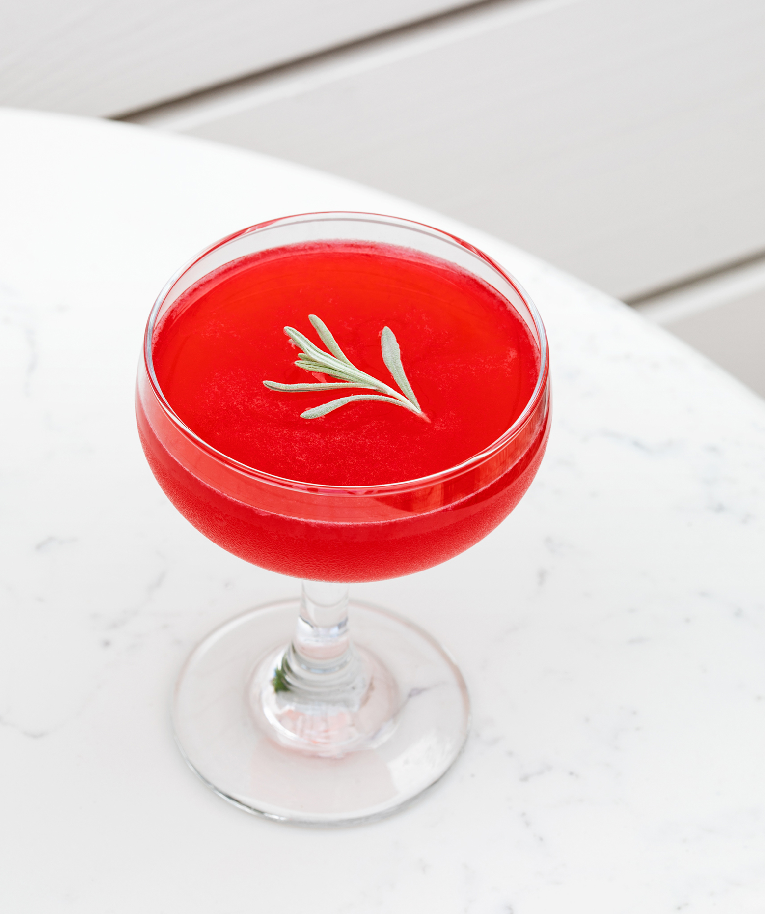 Let It Linger Cocktail with Rosemary Garnish