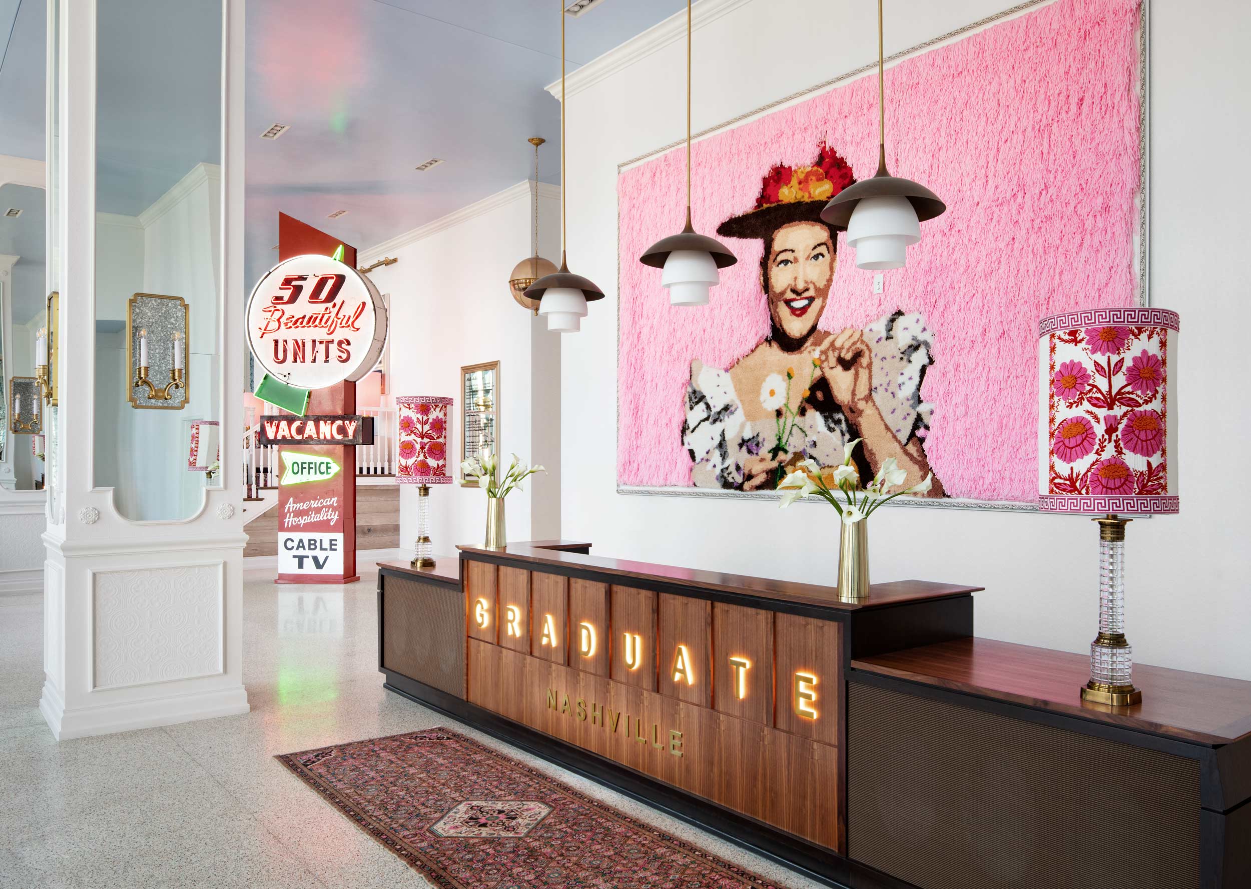 Check In Lobby Desk of Graduate Hotel Nashville with Neon Signs and Minnie Pearl Art